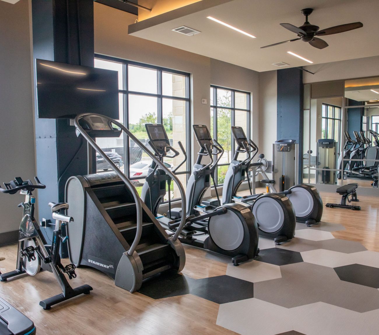 Fitness center with cardio and weight machines at McEwen Northside Apartments