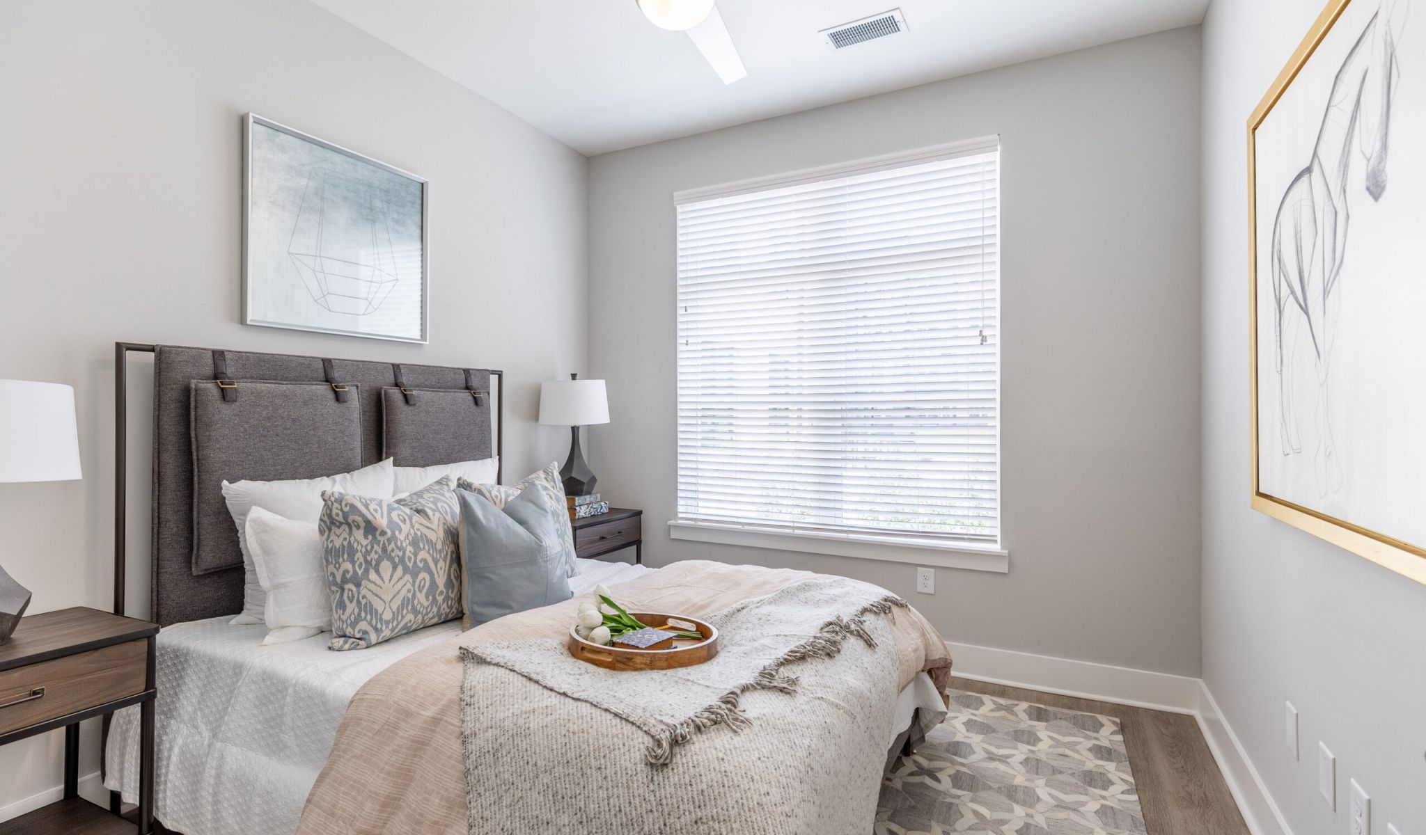 Furnished apartment bedroom with king sized bed at McEwen Northside Apartments